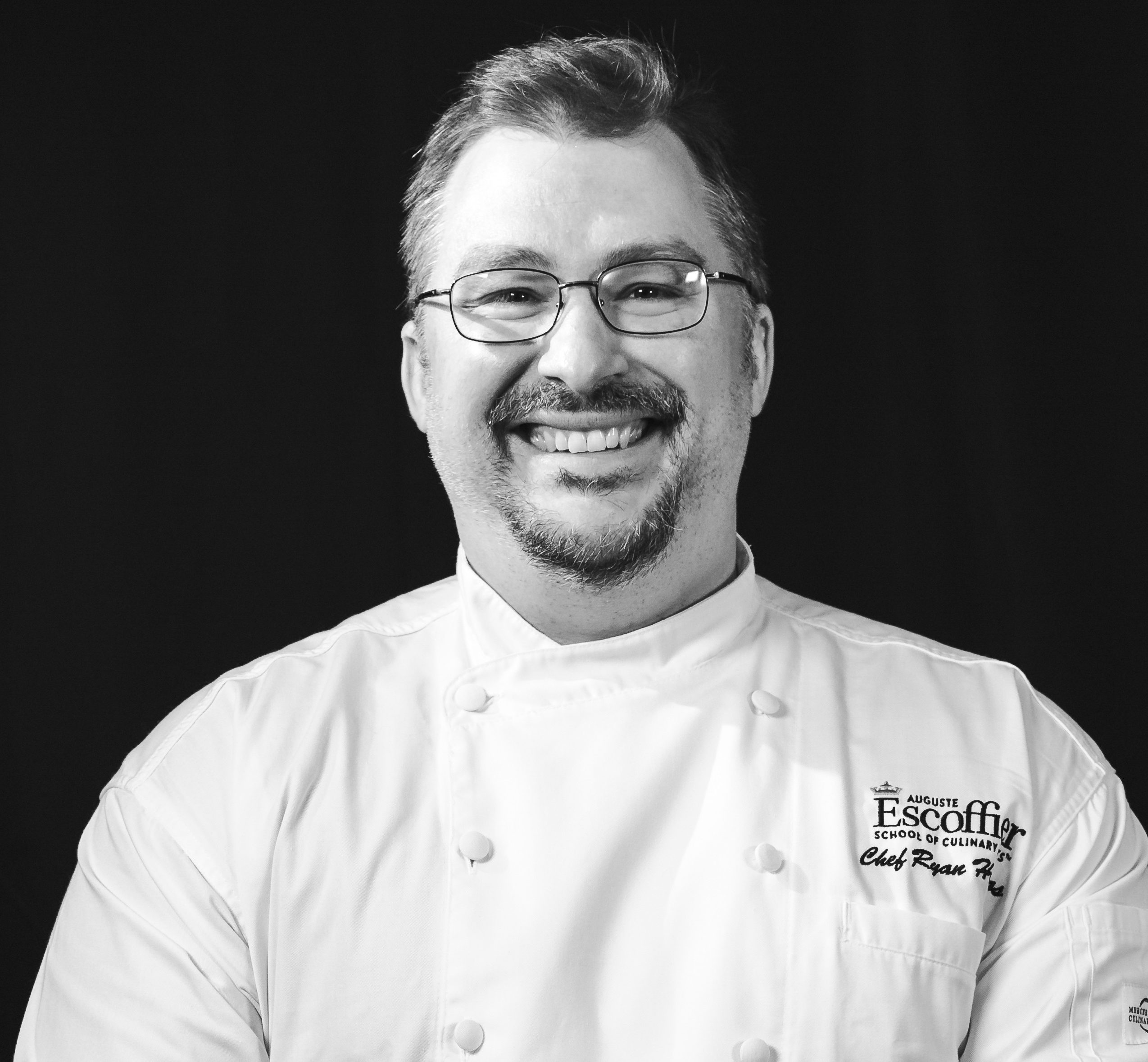 A photo of me, Ryan Hodros (author) in my chef's jacket.